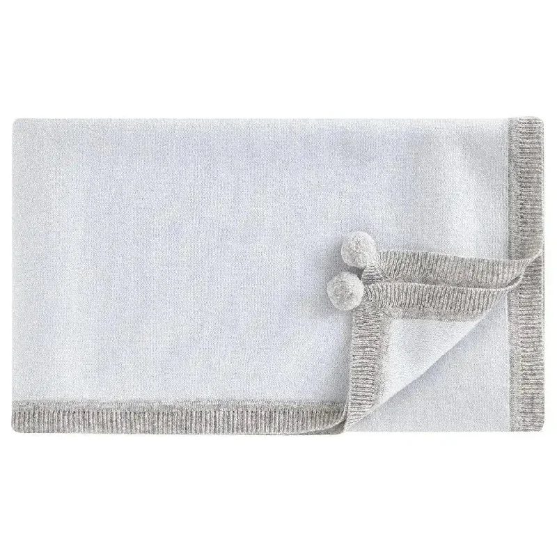 Cotton blankets for breathability and a lightweight feelCashmere pompoms blanket blue