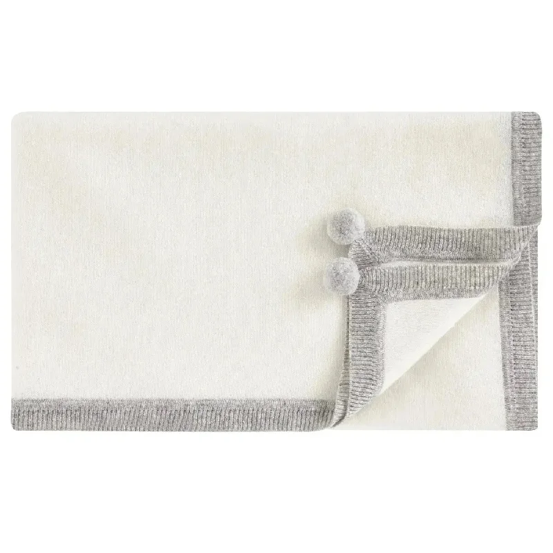 Cashmere blankets for ultimate softness and luxuryCashmere pompoms blanket clotted cream